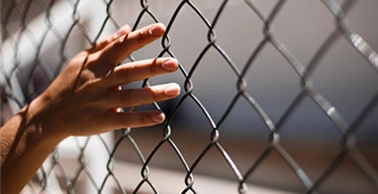 Hand on fence